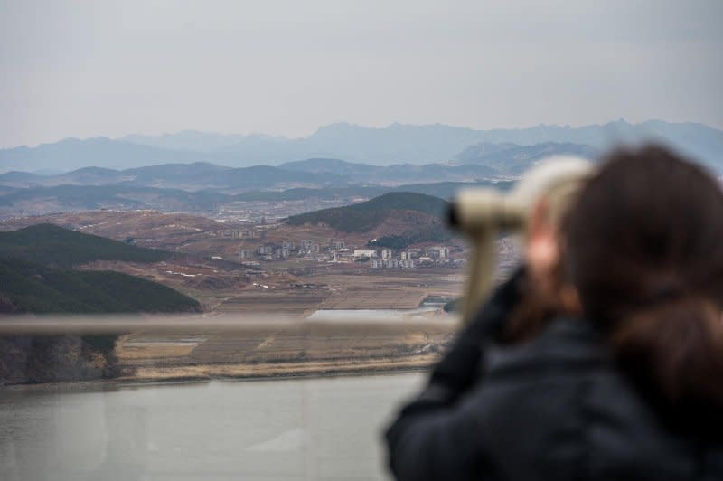 A visitor looks through binoculars at North Korea, located less than a mile away from the observatory at Aegibong. Photo by Thomas Maresca/UPI