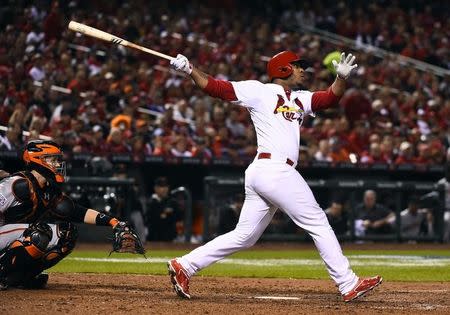 Oct 12, 2014; St. Louis, MO, USA; St. Louis Cardinals pinch hitter Oscar Taveras (18) hits a solo home run against the San Francisco Giants during the 7th inning in game two of the 2014 NLCS playoff baseball game at Busch Stadium. Jasen Vinlove-USA TODAY Sports