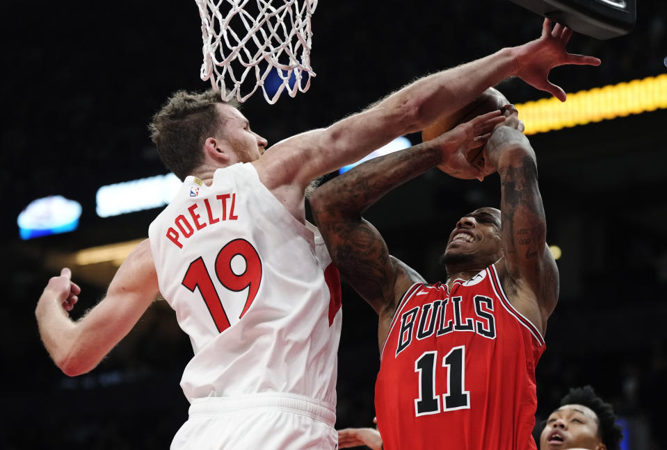 Chicago Bulls forward DeMar DeRozan (11) is stopped by Toronto Raptors centre Jakob Poeltl (19) during the first half of an NBA basketball game Tuesday, Feb. 28, 2023, in Toronto. (Frank Gunn/The Canadian Press via AP)