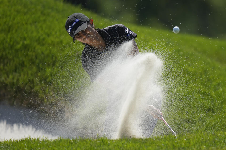 Aditi Ashok, of India, hits out of a bunker on the second green for an eagle during the final round of the LPGA Cognizant Founders Cup golf tournament, Sunday, May 14, 2023, in Clifton, N.J. (AP Photo/Seth Wenig)