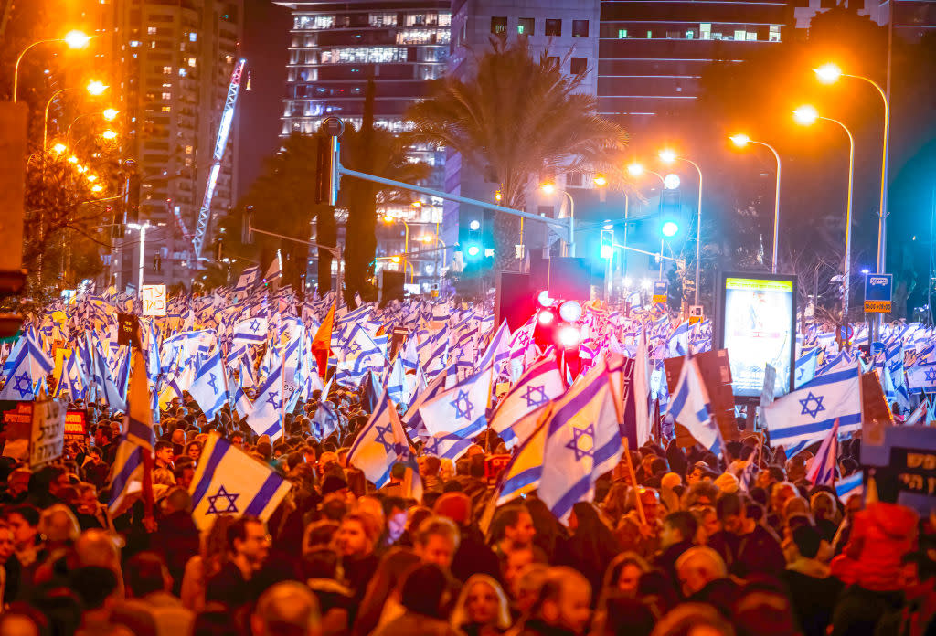 Crowd of protesters wave flags and placards during the