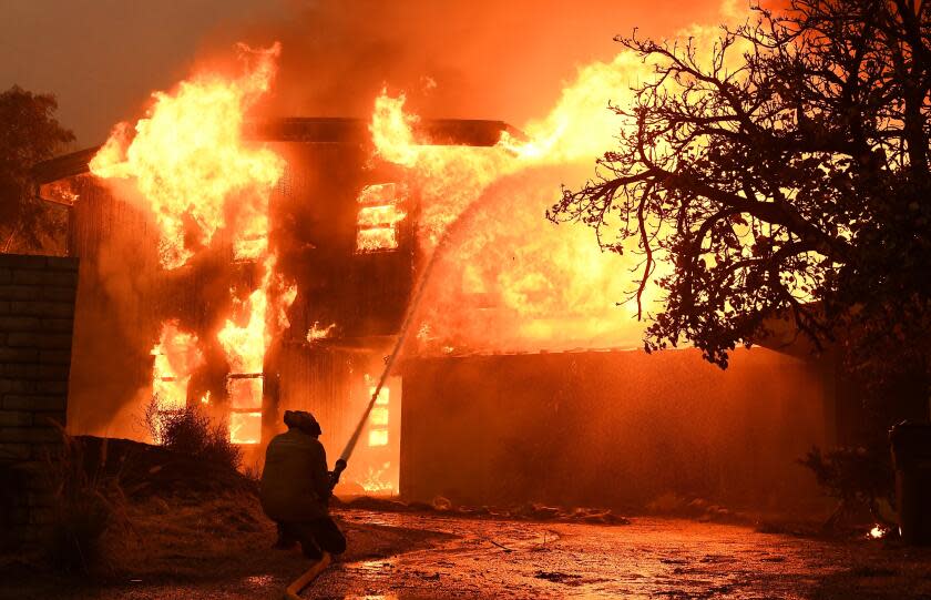 Wally Skalij  Los Angeles Times A FIREFIGHTER BATTLES a roaring house fire last year in Malibu, where residents must prepare for huge increases in fire insurance premiums regardless of the condition of their homes and properties.