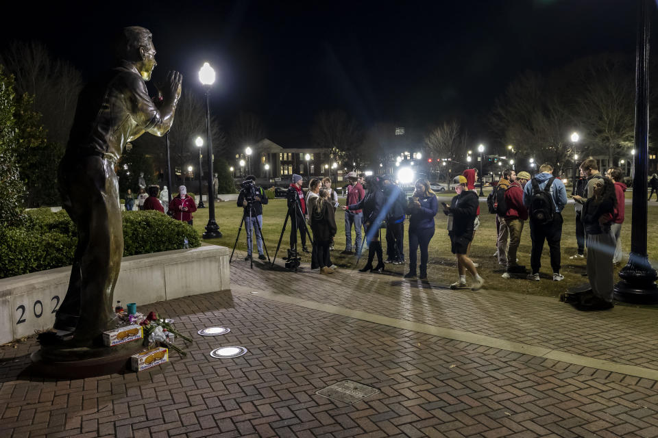 The statue of Alabama football. coach Nick Saban, along the Walk of Champions at Bryant-Denny Stadium, is the scene of gift drop-offs and lingering fans, Wednesday, Jan. 10, 2024, in Tuscaloosa, Ala. Saban, who won seven national championships — more than any other major college football coach — and turned Alabama back into a national powerhouse with six of those titles in just 17 seasons, is retiring, according to multiple outlets. (AP Photo/Vasha Hunt)