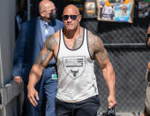 <p>Dwayne "The Rock" Johnson wears his mantra on his tank while arriving to <em>Jimmy Kimmel Live! </em>in Los Angeles on July 20.</p>