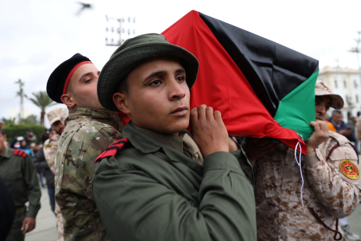 Libyan security personnel carry a coffin on Jan. 5, 2020, during the funeral of people who were killed in a UAE attack on a military academy in Tripoli. (Photo: Ismail Zetouni / Reuters)