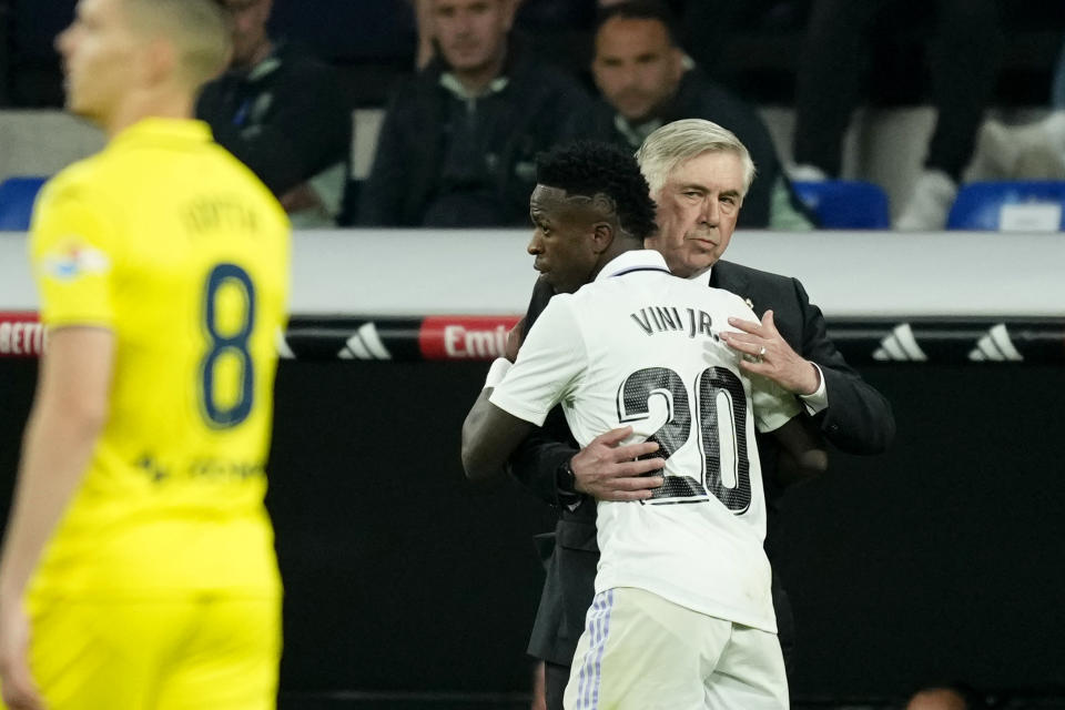 Real Madrid's Vinicius Junior celebrates with Real Madrid's head coach Carlo Ancelotti after scoring his side's second goal during a Spanish La Liga soccer match between Real Madrid and Villarreal at the Santiago Bernabeu stadium in Madrid, Saturday, April 8, 2023. (AP Photo/Jose Breton)