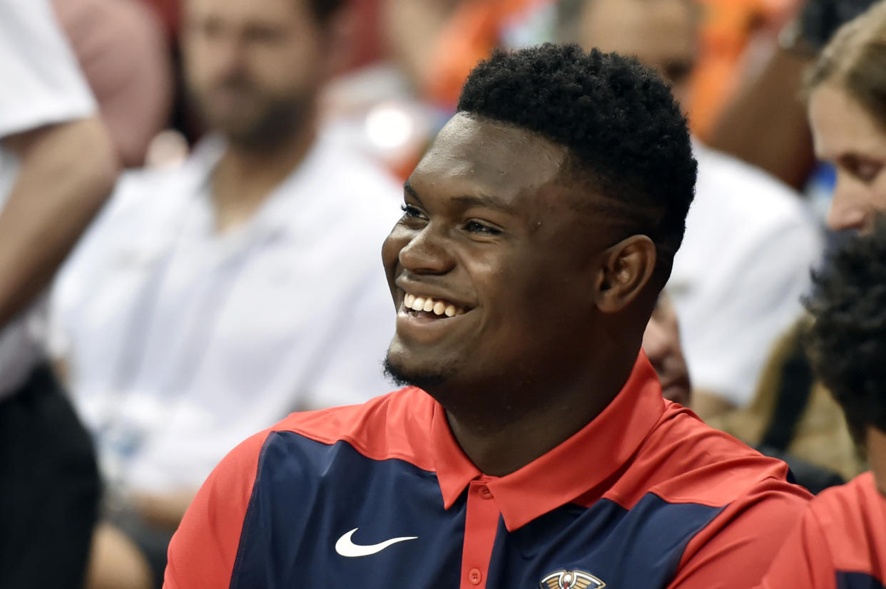 New Orleans Pelicans' Zion Williamson smiles while sitting on the bench during the first half of the team's NBA summer league basketball game against the Washington Wizards on Saturday, July 6, 2019, in Las Vegas. (AP Photo/David Becker)