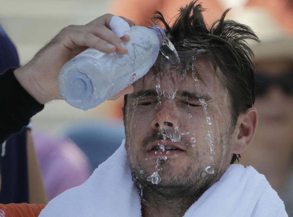 Stan Wawrinka, of Switzerland, pours water on his face during a changeover in his match against Ugo Humbert, of France, during the second round of the U.S. Open tennis tournament, Wednesday, Aug. 29, 2018, in New York. (AP Photo/Seth Wenig)