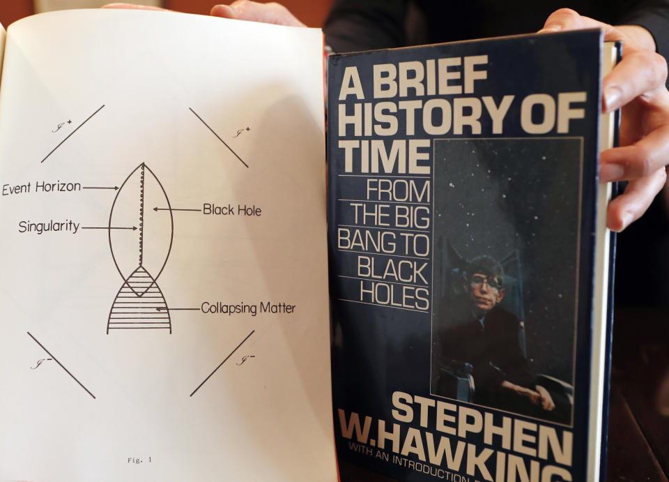 A Book, and scripts by Stephen Hawking are among the personal and academic possessions of Stephen Hawking at the auction house Christies in London, Friday, Oct. 19, 2018. The online auction announced Monday Oct. 22, 2018, by auctioneer Christie’s features 22 items from Hawking, including his doctoral thesis on the origins of the universe, with the sale scheduled for 31 October and 8 November. (AP Photo/Frank Augstein)