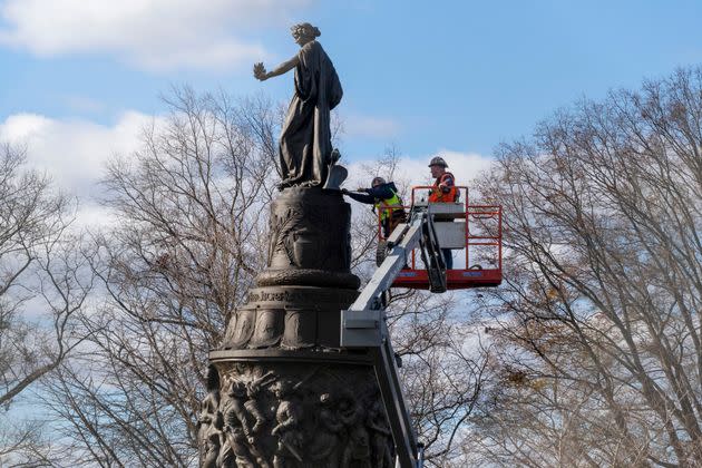 Workers prepare a Confederate memorial for removal in Arlington National Cemetery on Monday, Dec. 18 in Arlington, Virginia.