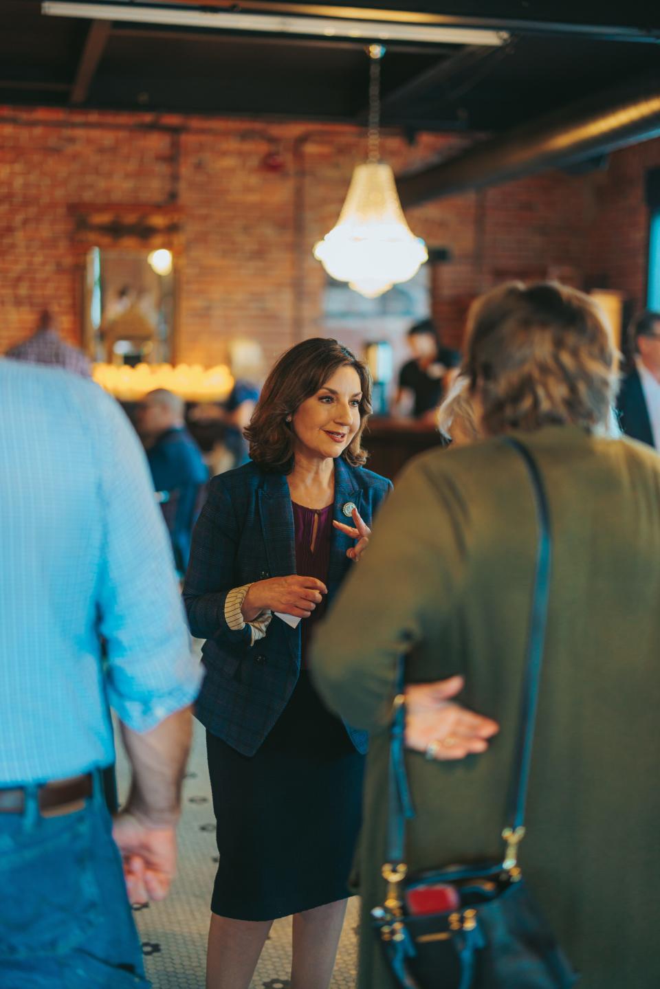 State schools Superintendent Joy Hofmeister, a gubernatorial candidate,  speaks one-on-one with attendees at her campaign fundraiser in the Johnstone-Sare Building on Wednesday.