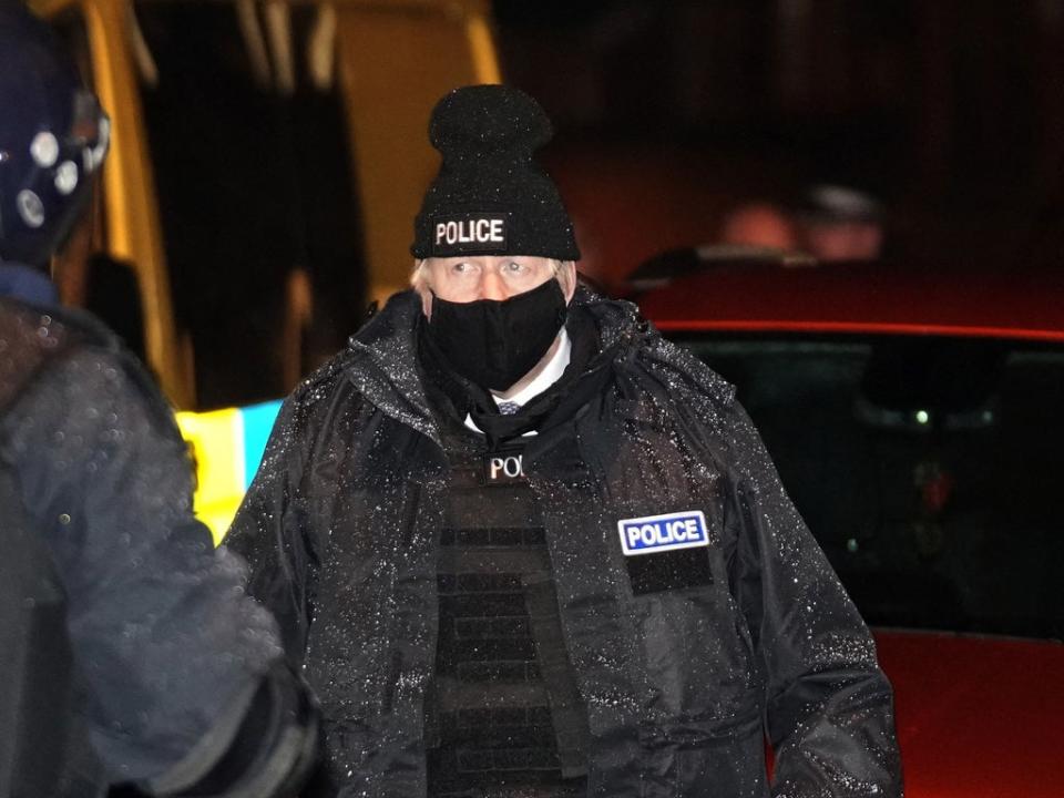 The plod of small things: Johnson dresses in police gear as he observes an early morning raid by Merseyside Police (POOL/AFP via Getty Images)