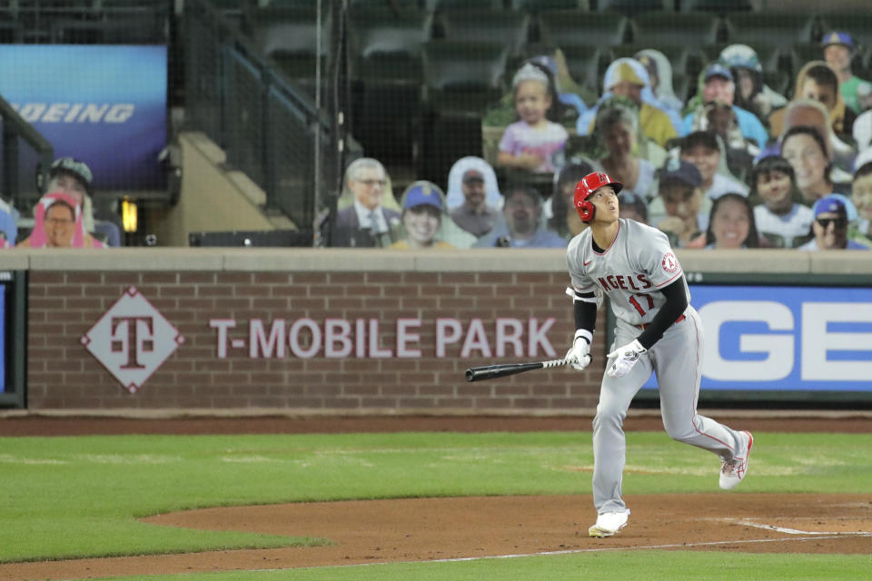 Los Angeles Angels' Shohei Ohtani watches his solo home run as he heads to first base during the second inning of a baseball game against the Seattle Mariners, Thursday, Aug. 6, 2020, in Seattle. (AP Photo/Ted S. Warren)