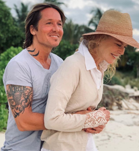 Nicole Kidman and Keith Urban celebrate their wedding anniversary in a loved-up photo of them looking relaxed on a beach. 