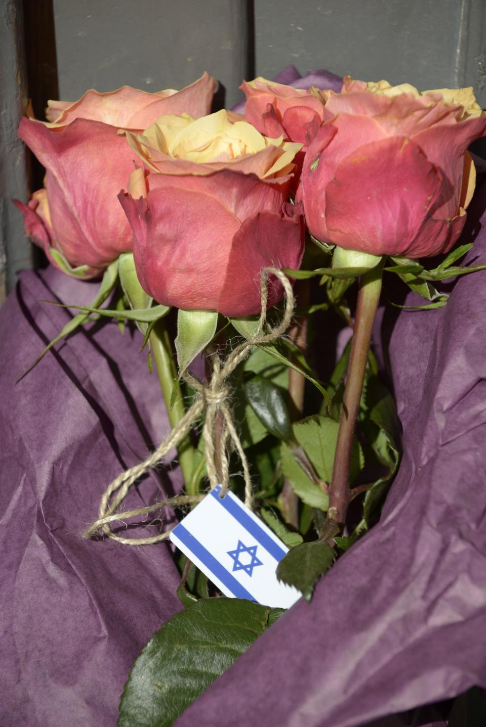 A bouquet of flowers with the Israeli flag is seen at the entrance of the Jewish Museum, the site of a shooting incident, in central Brussels