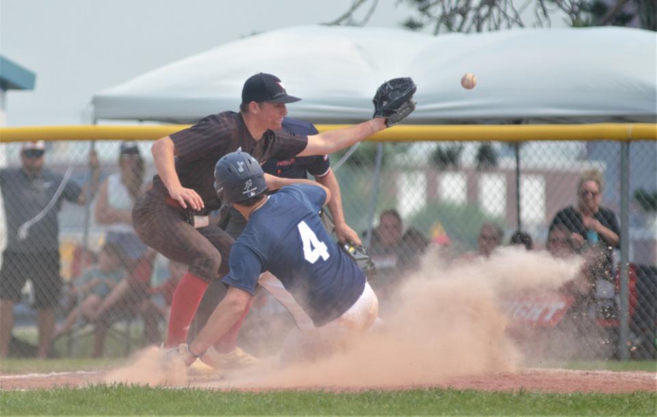 Dillon Croff slides safely into home during an MHSAA Division 4 district final between Gaylord St. Mary and Johannesburg-Lewiston on Saturday, June 3 in Gaylord, Mich.