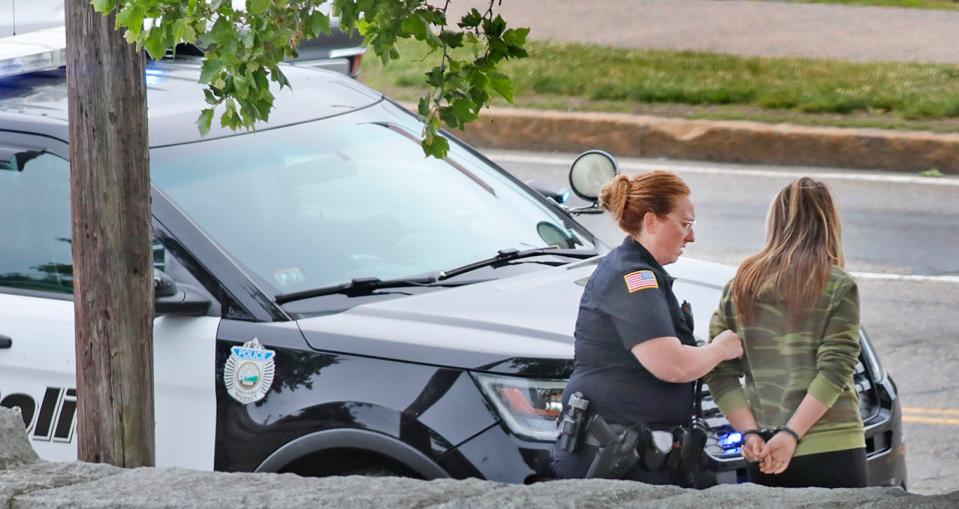 Quincy police officer Cheryl Potter takes a drugged-driving suspect who was driving a school van into custody on Southern Artery on Wednesday, June 1, 2022.