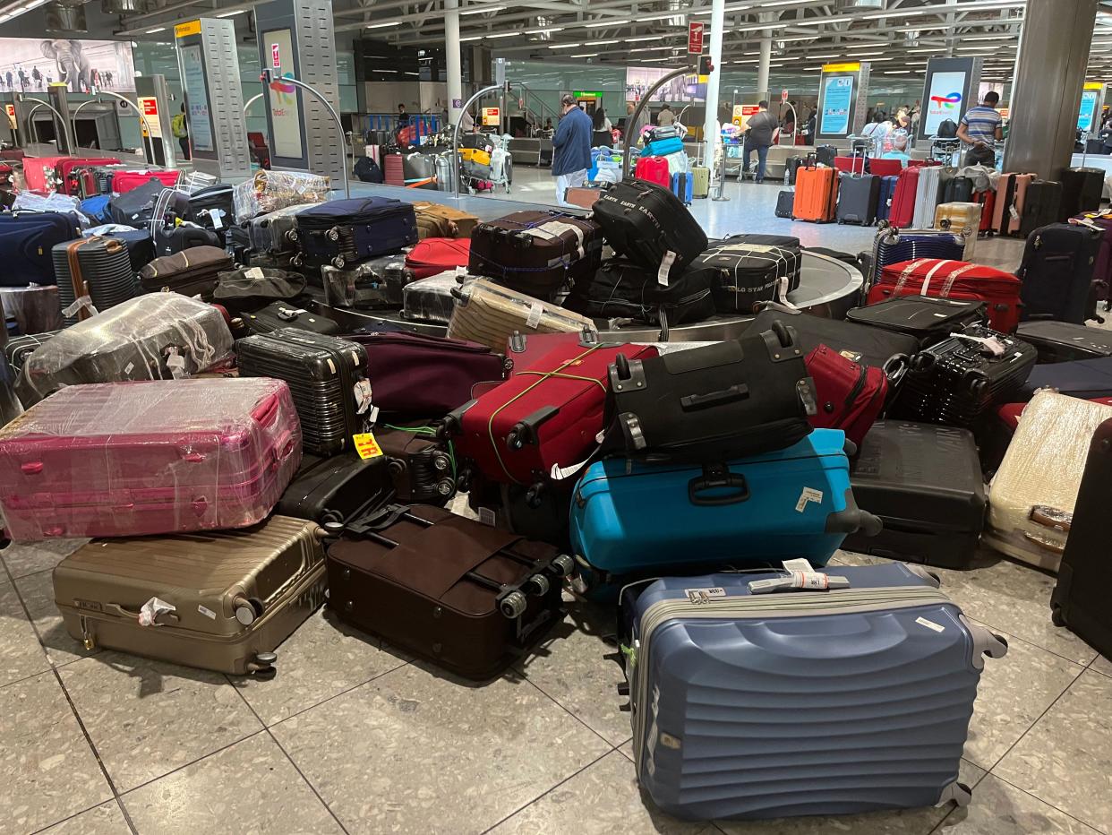 Suitcases are seen uncollected at Heathrow's Terminal Three bagage reclaim, west of London on July 8, 2022. - British Airways on Wednesday axed another 10,300 short-haul flights up to the end of October, with the aviation sector battling staff shortages and booming demand as the pandemic recedes.