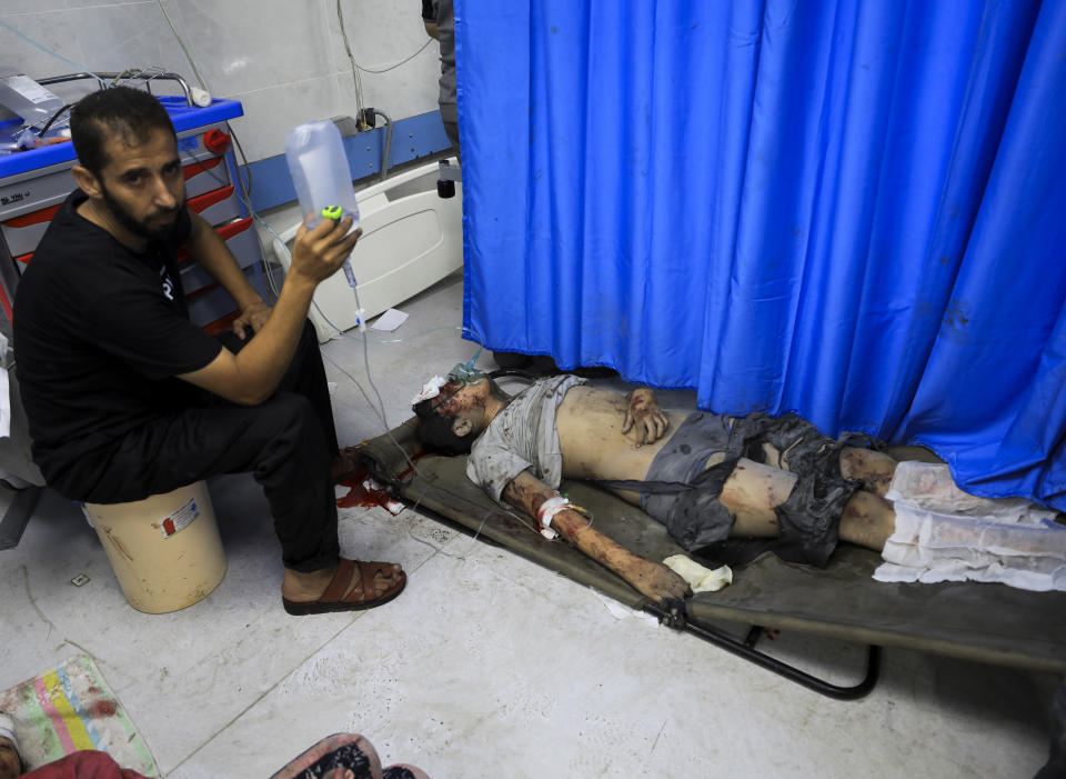 Palestinians wounded in the Israeli bombardment wait for treatment in Shifa Hospital in Gaza City, Monday, Oct. 23, 2023. (AP Photo/Yasser Qudih)