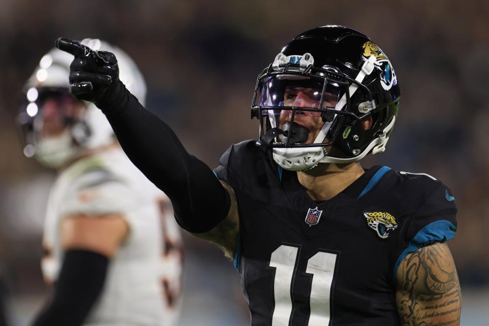 Jacksonville Jaguars wide receiver Parker Washington (11) picks up first down during the third quarter of a regular season NFL football matchup Monday, Dec. 4, 2023 at EverBank Stadium in Jacksonville, Fla. The Cincinnati Bengals defeated the Jacksonville Jaguars 34-31 in overtime. [Corey Perrine/Florida Times-Union]