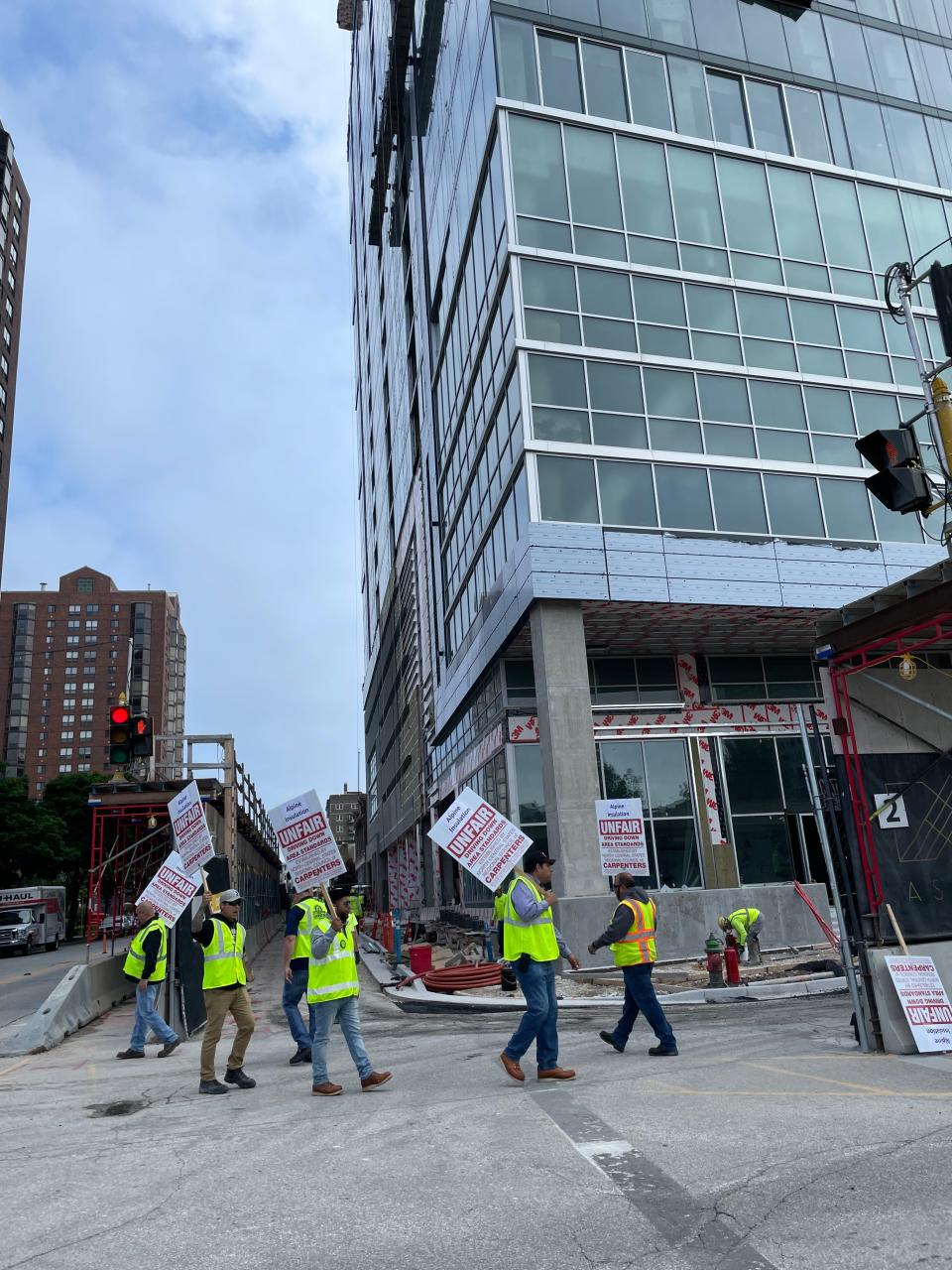 Workers represented by North Central States Regional Council of Carpenters picket Tuesday outside the Ascent apartment tower under construction at the corner of E. Kilbourn Avenue and N. Van Buren Street. They accuse Alpine Installation of engaging in unfair wage practices.