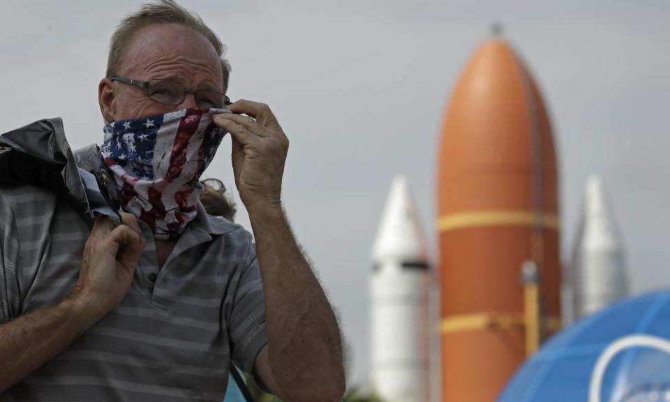 A man adjusts his mask at the Kennedy Space Center Visitor Complex, at Cape Canaveral on Thursday. The center reopened today after closing on 16 March due to the coronavirus pandemic.