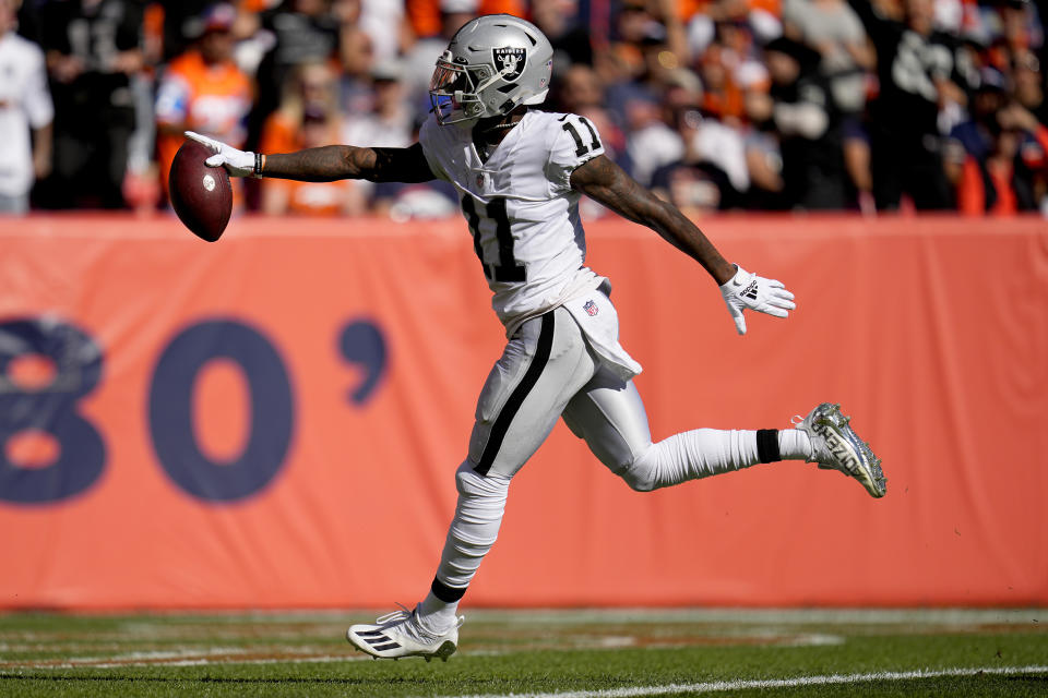 Las Vegas Raiders wide receiver Henry Ruggs III (11) scores a touchdown against the Denver Broncos during the first half of an NFL football game, Sunday, Oct. 17, 2021, in Denver. (AP Photo/Jack Dempsey)