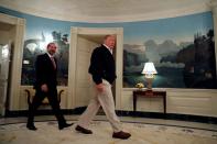 U.S. President Donald Trump accompanied by Health and Human Services (HHS) Secretary Alex Azar, arrives to sign the Congressional funding bill for coronavirus response at the White House in Washington