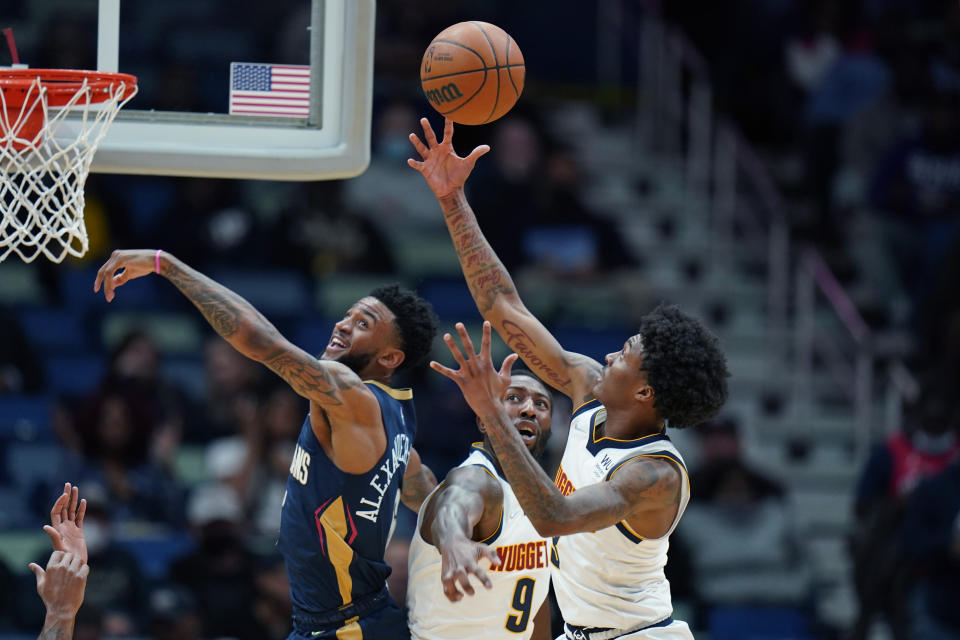 Denver Nuggets guard Bones Hyland (3) battles for a loose ball with guard Davon Reed (9) and New Orleans Pelicans guard Nickeil Alexander-Walker in the first half of an NBA basketball game in New Orleans, Wednesday, Dec. 8, 2021. (AP Photo/Gerald Herbert)