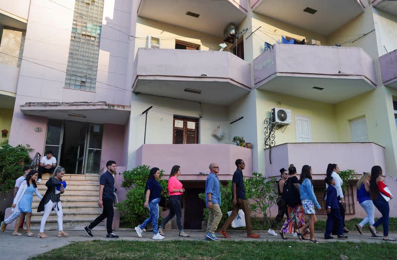 FILE PHOTO: People walk in line to the U.S. embassy in Havana