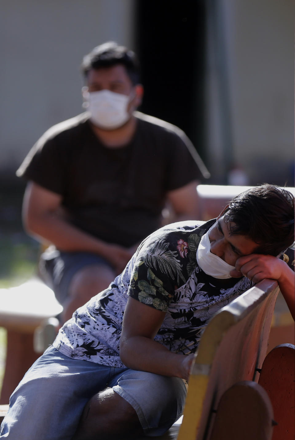 Youths wait for lunch at a school that was turned into a government-run shelter where citizens returning home are required by law to quarantine for two weeks and pass two consecutive COVID-19 tests, as a preventive measure amid the COVID-19 pandemic near Ciudad del Este, Paraguay, Wednesday, June 24, 2020. Some 8,500 have passed through the quarantine system already. (AP Photo/Jorge Saenz)