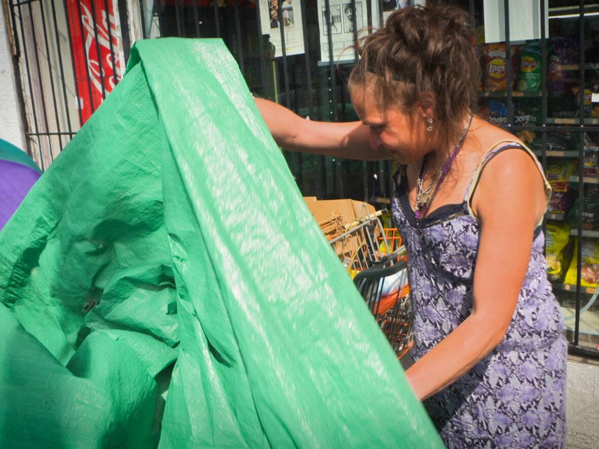 Jessica Anuroff says she is staying put in her tarp tent on East Hastings Street and hopes to find housing in the near future. (CBC News  - image credit)