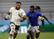 South Africa's Lukhanyo Am runs past the Namibian defence during the Rugby World Cup Pool B game at the City of Toyota Stadium between South Africa and Namibia in Toyota City, Japan, Saturday, Sept. 28, 2019. (AP Photo/Christophe Ena)