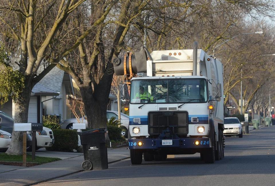 A Gilton Solid Waste Management truck picks up garbage (01-15-13) on Dorset Lane near Pridmore Avenue in Modesto, Ca.