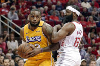 Los Angeles Lakers forward LeBron James (23) bumps Houston Rockets guard James Harden (13) as he drives to the basket during the first half of an NBA basketball game Saturday, Jan. 18, 2020, in Houston. (AP Photo/Michael Wyke)