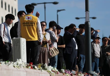 Family members of the victims visit the site of the boat accident involving South Korean tourists, next to the Margaret Bridge on the Danube river, in Budapest