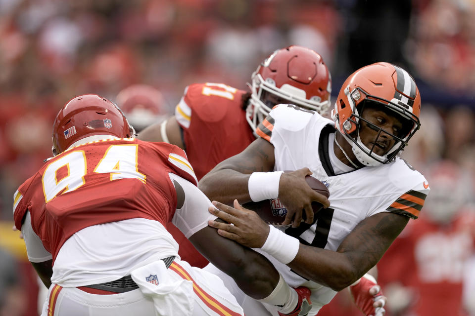 Cleveland Browns quarterback Deshaun Watson, right, is sacked by Kansas City Chiefs defensive end Malik Herring (94) during the first half of an NFL preseason football game Saturday, Aug. 26, 2023, in Kansas City, Mo. (AP Photo/Charlie Riedel)