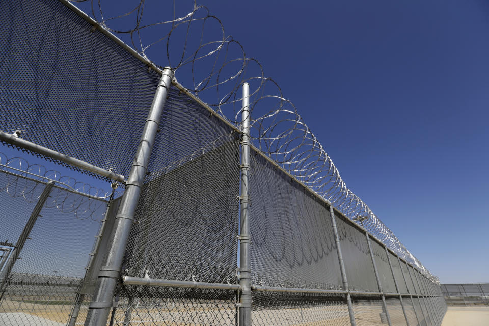 This Wednesday, Aug. 28, 2019, photo shows the Adelanto U.S. Immigration and Enforcement Processing Center operated by GEO Group, Inc. (GEO) a Florida-based company specializing in privatized corrections in Adelanto, Calif. California is banning the use of for-profit, private detention facilities, including those the federal government uses for immigrants awaiting deportation hearings. California Gov. Gavin Newsom announced Friday, Oct. 11, 2019 he had signed a measure into law that helps fulfill his promise to end the use of private prisons.(AP Photo/Chris Carlson)