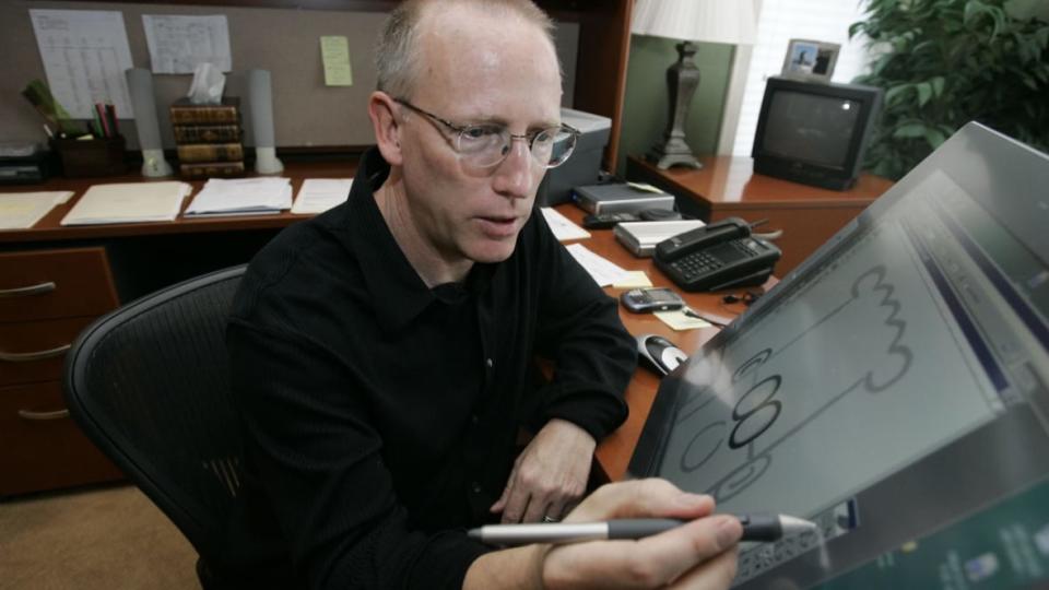 Scott Adams, creator of “Dilbert,” works on his comic strip in his studio in Dublin, California, in October 2006. Adams is back with another round of what can be perceived as insensitive remarks after dozens of newspapers severed ties with him for saying that white people should get away from Black people. (Photo: Marcio Jose Sanchez/AP, File)