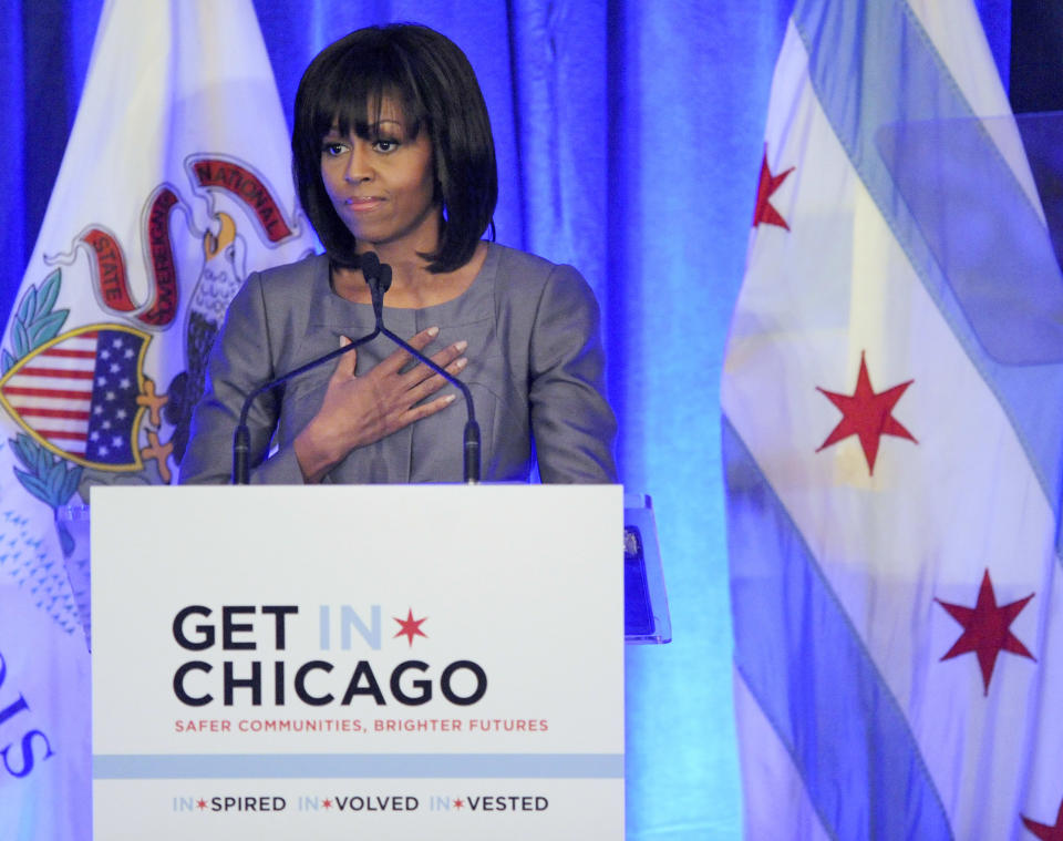 FILE - In this April 10, 2013 file photo, first lady Michelle Obama speaks at a luncheon in Chicago about the death of 15-year-old Hadiya Pendleton who was shot and killed Jan. 29, 2013 in a park during a gang dispute she had nothing to do with about a mile from the first family's Chicago home. The low point so far in Chicago’s closely watched battle with street gangs may have been the day Feb. 9, 2013, when the first lady came home for Hadiya's funeral. Since Pendleton's death, the number of homicides and other violent crimes that turned Chicago into a national symbol of gun violence have fallen sharply after the city and police changed strategies. (AP Photo/Paul Beaty, File)