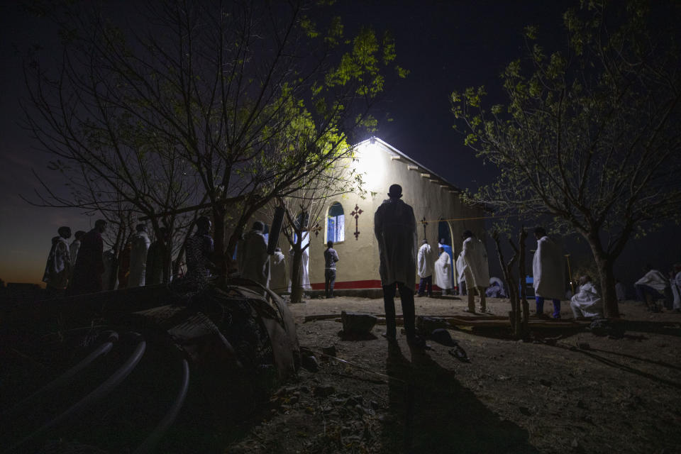 Tigrayan refugee Abraha Kinfe Gebremariam, 40, center, prays at a church early in the morning in Hamdayet, eastern Sudan, near the border with Ethiopia, on March 21, 2021. (AP Photo/Nariman El-Mofty)