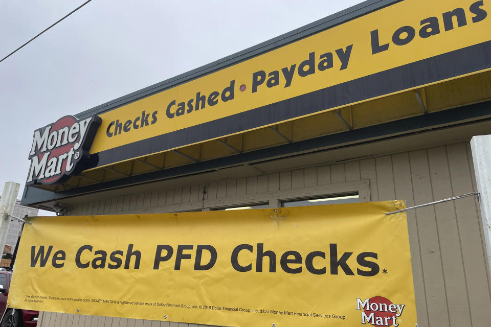 A money services store in Anchorage, Alaska, is shown Oct. 2, 2023, advertising PFD check cashing services as the state plans to begin distributing $1,312 checks to nearly every Alaskan this week. The PFD, or the Permanent Fund dividend, is the annual share of the earnings from the state's nest-egg oil-wealth fund given to residents. (AP Photo/Mark Thiessen)