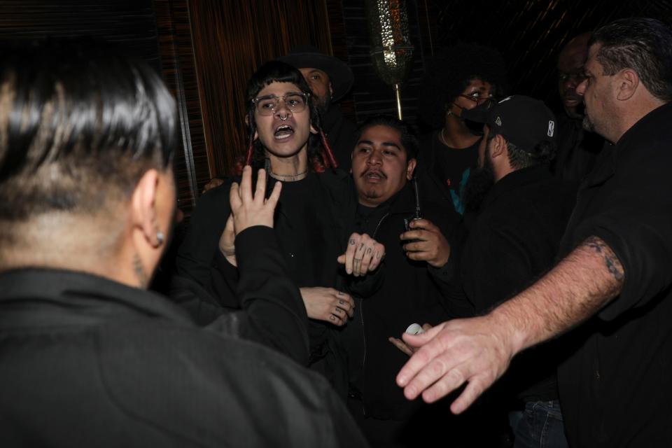 Security escorts members of the audience protesting the Israel-Gaza war at a campaign event hosted by Adam Schiff, after Schiff advanced in a runoff senate race in California on March 5, 2024. Schiff spoke in front of a couple hundred people before members of the crowd began protesting the Israel-Gaza war and caused the event to end prematurely.