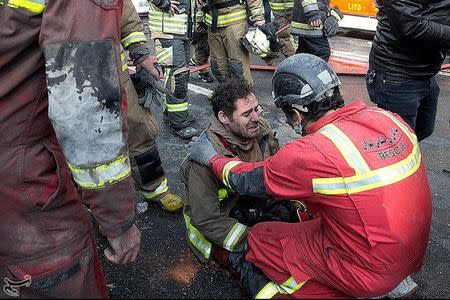 A firefighter reacts at the site of a blazing high-rise building in Tehran, Iran January 19, 2017. Tasnim News Agency/Handout via REUTERS