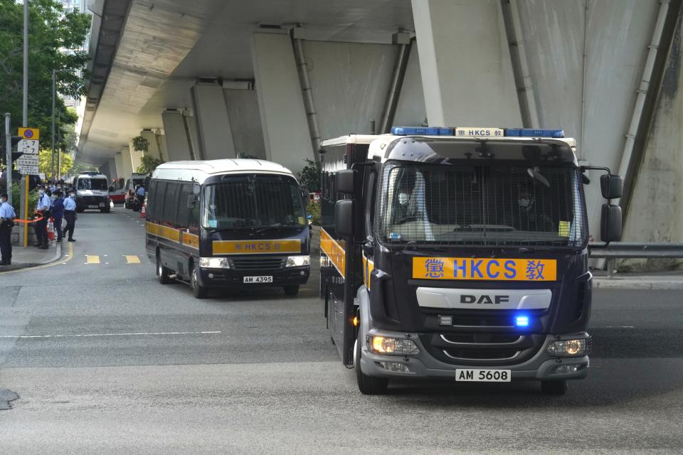 A prison van, right, carrying Hong Kong pro-democracy activist Andy Li leaves court in Hong Kong, Wednesday, April 7, 2021. Li is one of the 12 young pro-democracy activists captured at sea last year by mainland Chinese authorities and returned to Hong Kong in March, as Li is charged with an offense under the newly-invented National Security Law. (AP Photo/Kin Cheung)