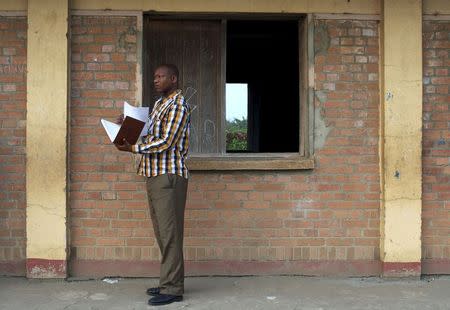 A staff of the Burundian National Independent Electoral Commission stands outside a polling station at Cibitoke neighbourhood during a parliamentary election near capital Bujumbura, in Burundi June 29, 2015. REUTERS/Paulo Nunes dos Santos