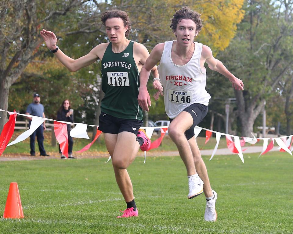 Hingham’s Brendan Burm just edges out Graham Heinrich at the finish line to finish first overall in their dual meet at Hingham High on Wednesday, Oct. 11, 2023. Brendan won by 0.034 seconds with a time of 15:59.649. Marshfield boys won 27-28 while Marshfield girls won 19-36.