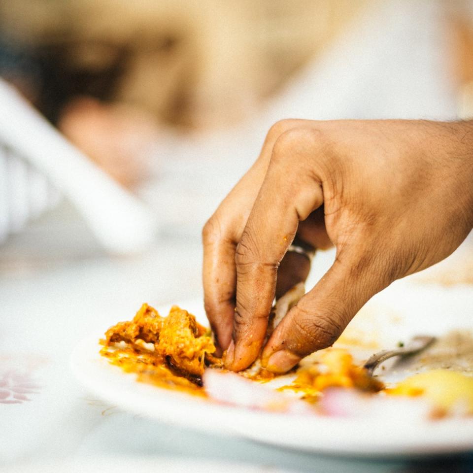 A person eats with their hands in India (iStock)