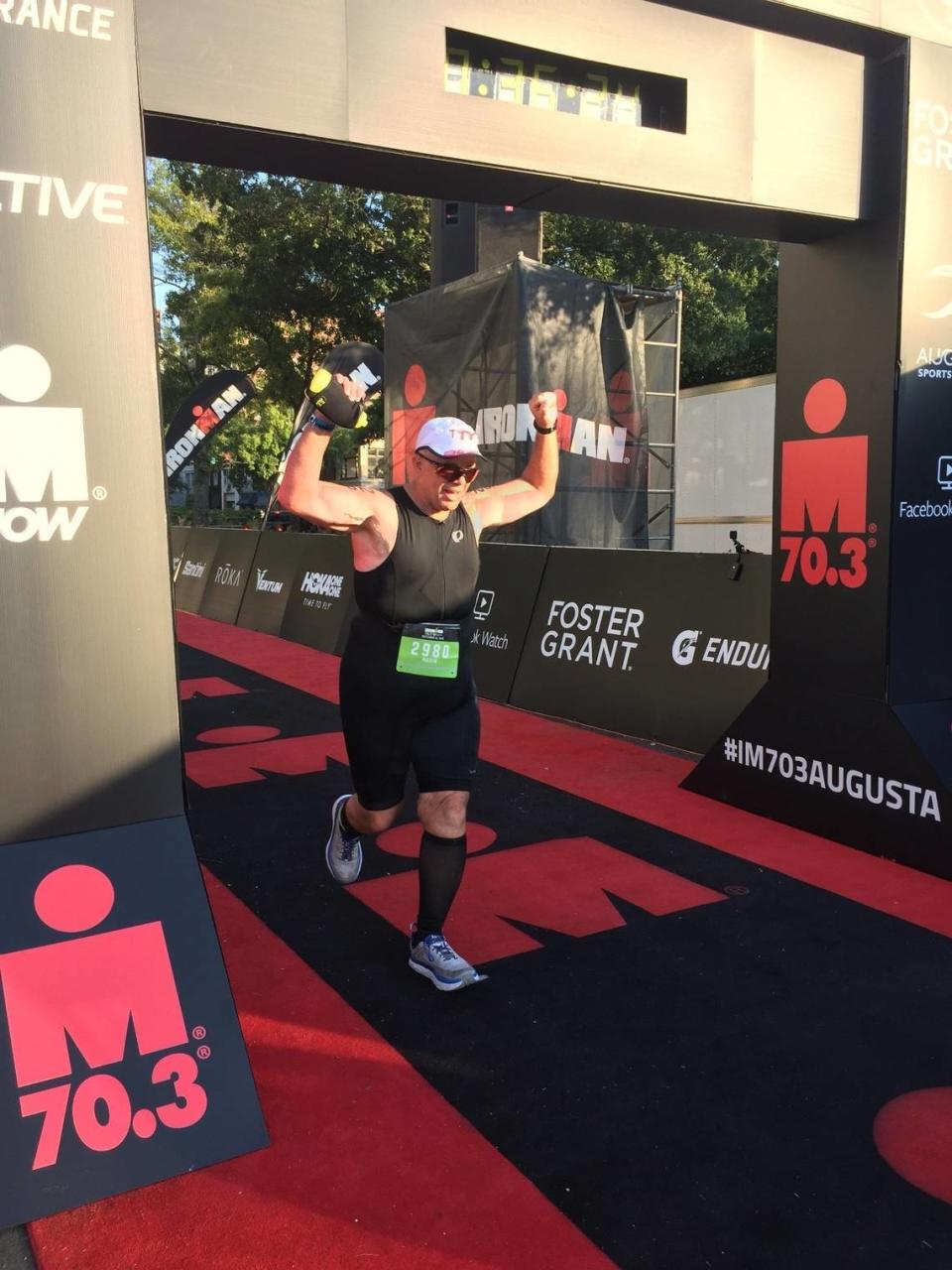 Mario Farnesi crosses the finish line at the Half Ironman competition in Augusta, Georgia, in September 2019. The race consists of a 1.2-mile swim, a 56-mile bike ride and a 13.1-mile run (a half marathon).