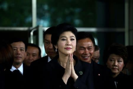 Ousted former Thai prime minister Yingluck Shinawatra greets supporters as she arrives at the Supreme Court in Bangkok, Thailand, July 21, 2017. REUTERS/Athit Perawongmetha/Files